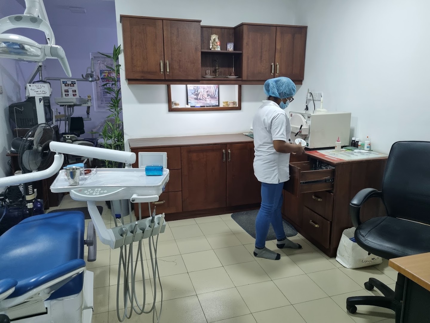 Clinic staff member preparing equipment in a treatment room